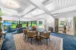 Experience luxury living in this stunning property, featuring a spacious dining area with a modern glass table and stylish chairs.