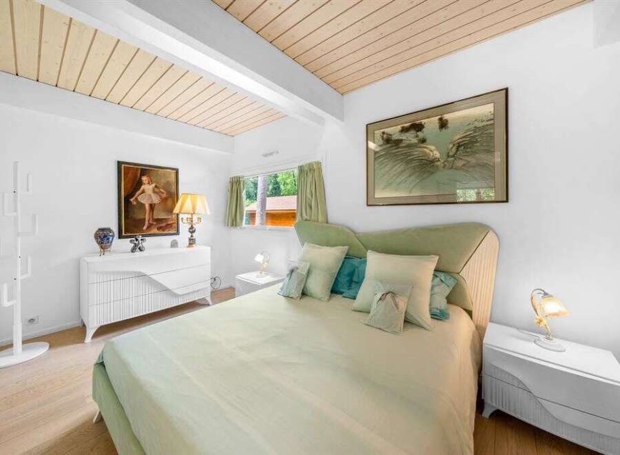 Step into this serene bedroom, featuring a calming color palette and natural light.
