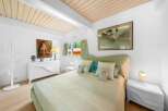 Step into this serene bedroom, featuring a calming color palette and natural light.