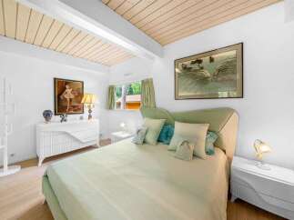 Step into this serene bedroom, featuring a calming color palette and natural light.
