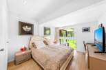This stunning bedroom offers a serene retreat with its elegant design and natural light.