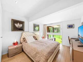 This stunning bedroom offers a serene retreat with its elegant design and natural light.