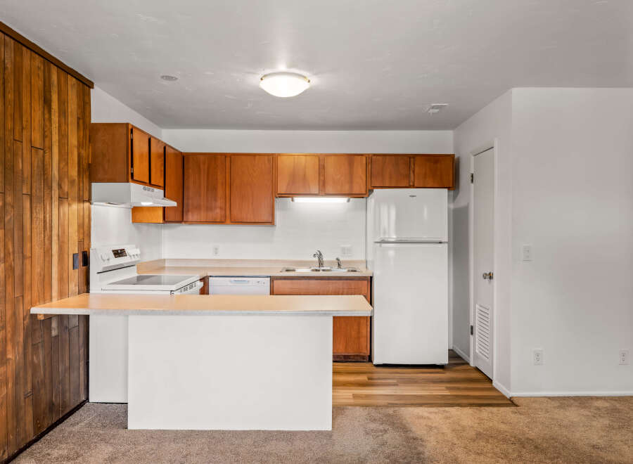 Discover this charming kitchen with warm wood cabinetry and a functional layout.