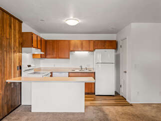 Discover this charming kitchen with warm wood cabinetry and a functional layout.