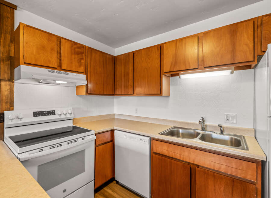 This charming kitchen features warm wood cabinetry and a functional layout, perfect for everyday living.