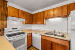 This charming kitchen features warm wood cabinetry and a functional layout, perfect for everyday living.