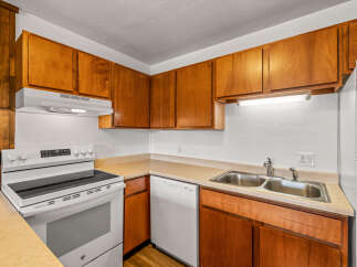 This charming kitchen features warm wood cabinetry and a functional layout, perfect for everyday living.