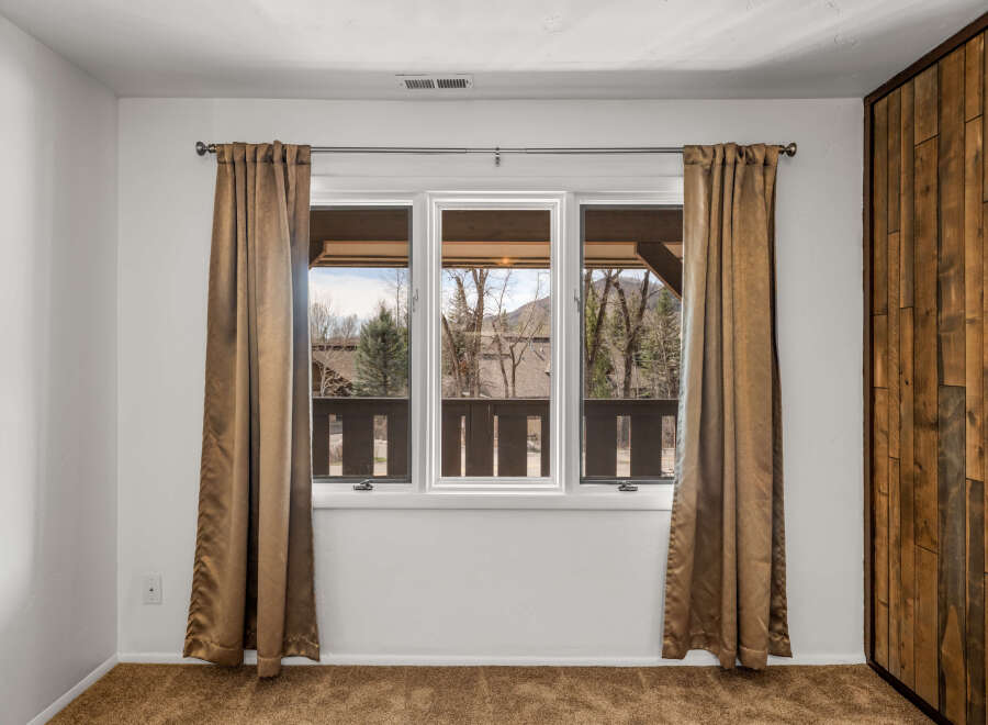 This inviting room features a large window that offers stunning views of the surrounding landscape.