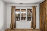This inviting room features a large window that offers stunning views of the surrounding landscape.