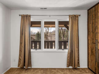 This inviting room features a large window that offers stunning views of the surrounding landscape.