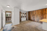 Step into this inviting space, featuring a unique wood-paneled accent wall that adds warmth and character.