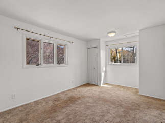 This inviting bedroom offers a bright and airy atmosphere, perfect for relaxation.
