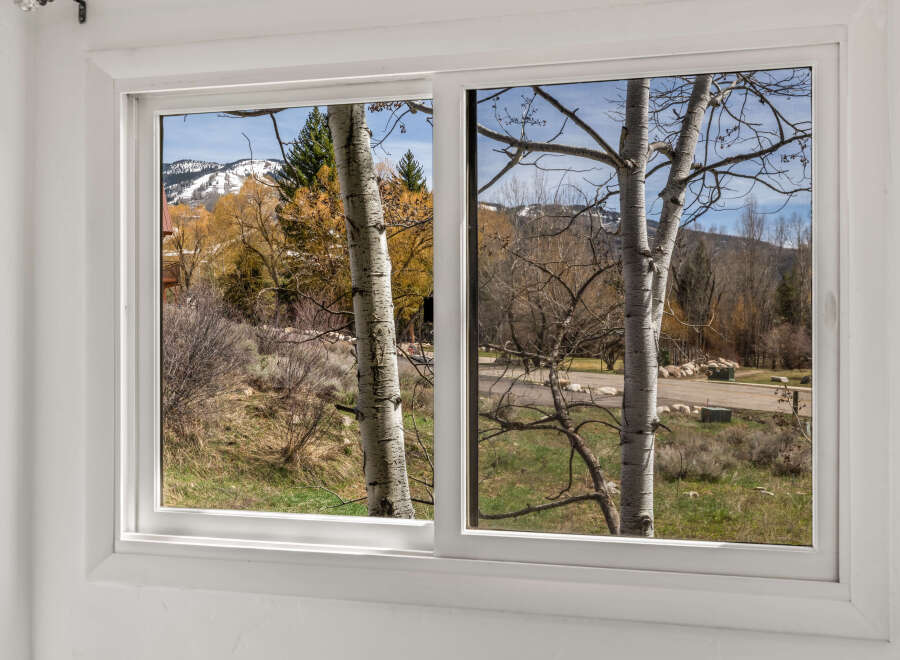 Enjoy breathtaking views from this stunning property! This home features a large window that showcases the beauty of the surrounding landscape.