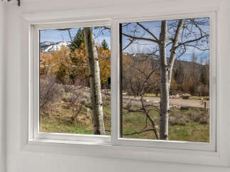 Enjoy breathtaking views from this stunning property! This home features a large window that showcases the beauty of the surrounding landscape.