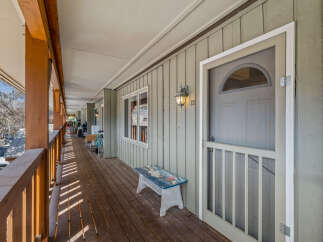 This charming property features a welcoming porch, perfect for enjoying the outdoors.