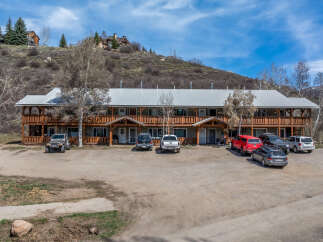Discover a charming multi-unit property nestled in a picturesque setting.