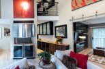 This stunning home boasts an open-concept living area with a unique blend of modern and rustic design elements.