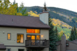 Mountain view home with a balcony and large windows.