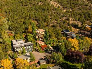 Nestled amidst a vibrant tapestry of autumn foliage, this stunning property offers a serene escape.