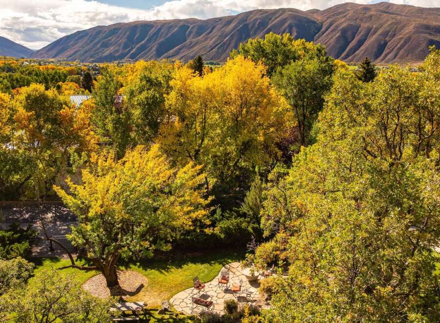 Nestled amidst the vibrant hues of autumn, this property offers a serene escape with stunning mountain views.