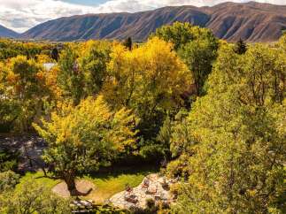 Nestled amidst the vibrant hues of autumn, this property offers a serene escape with stunning mountain views.