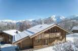 Nestled in a picturesque winter wonderland, this stunning wooden chalet offers a serene escape.