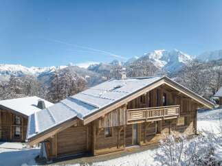 Nestled in a picturesque winter wonderland, this stunning wooden chalet offers a serene escape.