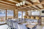 Experience luxury living in this stunning chalet, featuring a spacious dining area perfect for entertaining.