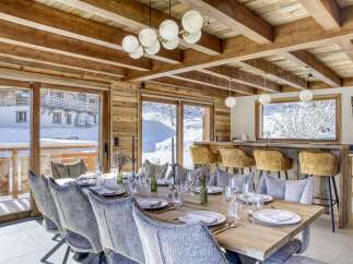 Experience luxury living in this stunning chalet, featuring a spacious dining area perfect for entertaining.