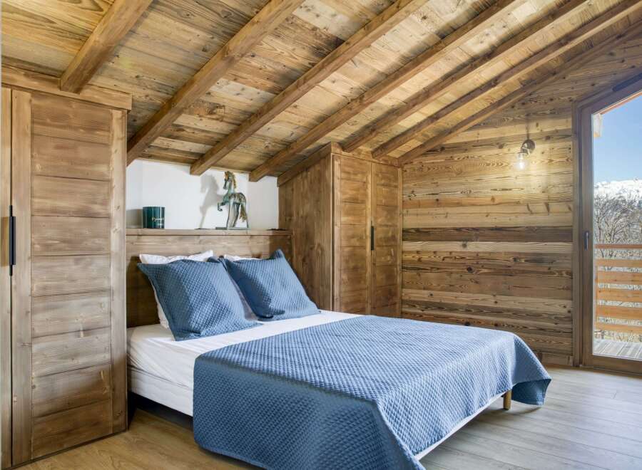 Experience the charm of this cozy bedroom, featuring rustic wooden accents and a serene ambiance.