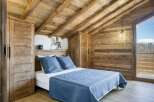 Experience the charm of this cozy bedroom, featuring rustic wooden accents and a serene ambiance.