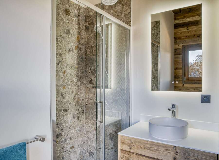 This stunning bathroom features a modern design with a touch of rustic charm.