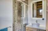 This stunning bathroom features a modern design with a touch of rustic charm.