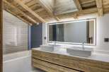 This stunning bathroom boasts a rustic charm with its wooden ceiling and cabinetry, creating a warm and inviting atmosphere.