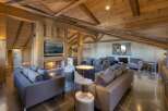Experience luxury living in this stunning chalet, featuring a cozy fireplace and a modern kitchen.