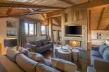 Experience luxury living in this stunning property, featuring a cozy fireplace and a modern entertainment setup.