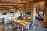 Experience luxury living in this stunning chalet, featuring a cozy fireplace and a modern kitchen.