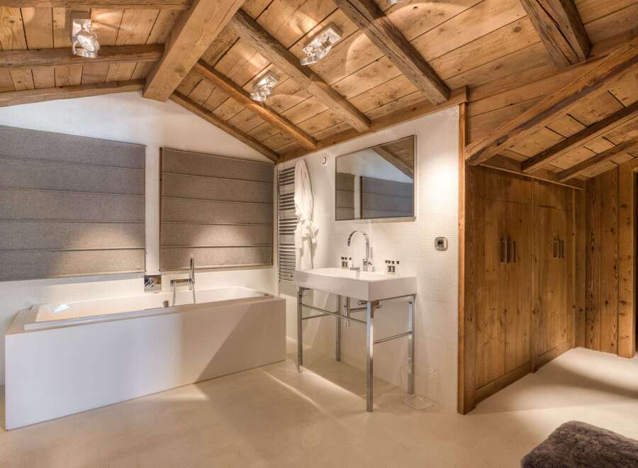 Experience luxury in this stunning bathroom featuring a modern design and rustic charm.