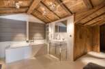 Experience luxury in this stunning bathroom featuring a modern design and rustic charm.