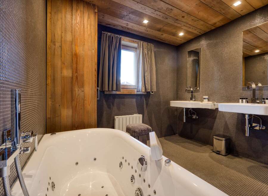 This luxurious bathroom features a modern design with a relaxing jacuzzi tub.