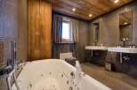 This luxurious bathroom features a modern design with a relaxing jacuzzi tub.