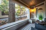 Step into a charming retreat with this inviting porch, perfect for enjoying the serene surroundings.