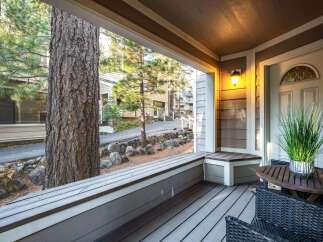 Step into a charming retreat with this inviting porch, perfect for enjoying the serene surroundings.