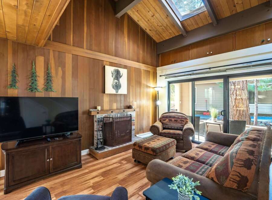 Step into this cozy living space, featuring a charming fireplace and a large flat-screen TV, perfect for relaxing evenings.