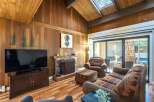 Step into this cozy living space, featuring a charming fireplace and a large flat-screen TV, perfect for relaxing evenings.