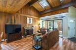 Step into this inviting living space, featuring a cozy fireplace and a stylish TV setup.