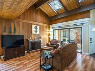 Step into this inviting living space, featuring a cozy fireplace and a stylish TV setup.