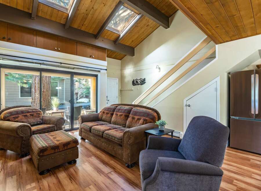 Step into this inviting living space, featuring a cozy sofa and armchairs perfect for relaxation.