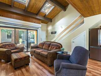 Step into this inviting living space, featuring a cozy sofa and armchairs perfect for relaxation.