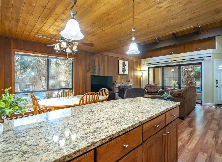 Step into this inviting home featuring a cozy living space with a fireplace and a well-equipped kitchen.